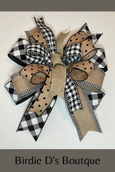 a black and white checkered bow with polka dots on the bottom is shown in front of a white background