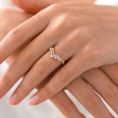 a woman's hand with a diamond ring on it