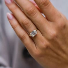 a woman's hand with a diamond ring on it