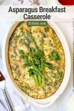 asparagus breakfast casserole in a white dish with green garnish