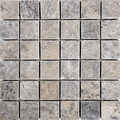 a white and grey tile wall with squares