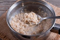 a spoon full of oatmeal sitting on top of a cloth