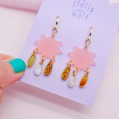 Stand out from the crowd with these pretty swishy statement earrings . The beautiful earrings are made from 4 different types of acrylic. The main star is made from a blush pink semi transparent frosted acrylic with tiny stars etched into one side. Hanging from each star are three little drops made from gold glitter, Gold mirror and white pearlescent acrylics . The star has huggie style gold plated hoops attached . Your jewellery will arrive in a pretty pink and gold branded drawstring bag  To k Trendy Pink Star-shaped Jewelry, Pink Star Earrings For Party, Pink Star-shaped Party Earrings, Whimsical Star-shaped Party Jewelry, Trendy Pink Jewelry With Star Charm, Pink Star-shaped Jewelry For Party, Pink Star Charm Jewelry, Pink Star Charm Dangle Earrings, Pink Dangle Earrings With Star Charm