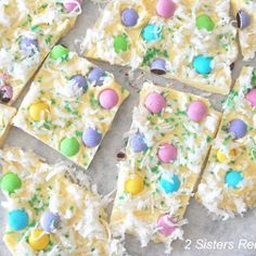 some kind of cake that is decorated with candy eggs and sprinkles on it