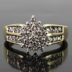 a diamond cluster ring on a reflective surface