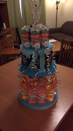 a cake made to look like a tiered tower with cans on it and ribbons around the top