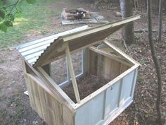 a chicken coop built into the side of a tree