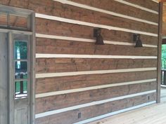 a wooden wall with two bells on it