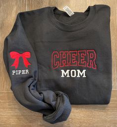 tis the season to rep you favorite cheerleader! Cheer will be the same color as now and, names will be the same color.  This sweatshirt is made to order on a Gildan  crewneck. Listing shows the color Sand with Black thread. For local pickup please use code "LOCAL" at checkout to remove shipping expenses.  Thank you!! Black Sweatshirt For Cheerleading In Fall, Black School Spirit Sweatshirt For Cheerleading, Customizable School Spirit Sweatshirt For Cheerleading, Customizable Team Spirit Sweatshirt For Cheerleading, Customizable Cotton Cheerleading Sweatshirt, School Spirit Sweatshirt For Cheerleading In Fall, Customizable Cotton Sweatshirt For Cheerleading, Varsity Sweatshirt For Cheerleading In Fall, Pre-shrunk Cheerleading Sweatshirt For Fall