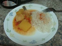 a plate with rice, meat and vegetables on it next to an instant pressure cooker