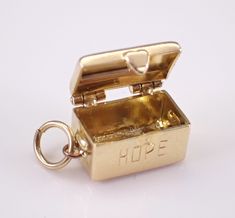 Vintage 14K Yellow Gold Hope Chest Charm Pendant. This charm is 14K Yellow gold and weighs 2.4 grams. This treasure chest is absolutely adorable with an opening top.  This charm measures 11 X 7 X 6 mm.  I will ship this pendant promptly in a gift pouch. 14k Gold Jewelry With Box Clasp For Gift, Gold Box-shaped Jewelry For Valentine's Day, Cathedral Building, Gift Pouch, Treasure Chest, Hope Chest, Charm Pendant, Heart Pendant, Jewelry Crafts