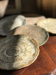 three plates sitting on top of a wooden table