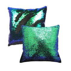 two green and blue sequinized pillows sitting on top of each other, one has a black stripe down the middle