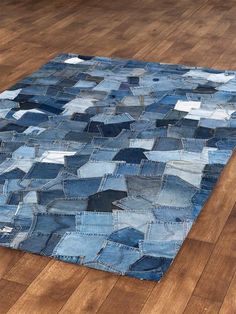 an area rug made out of old jeans on the floor in a room with hard wood floors