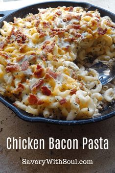 chicken bacon pasta casserole in a skillet with a serving spoon on the side