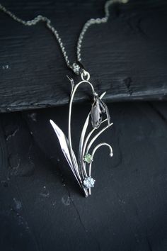 ITEM DESCRIPTION: The size H 5 cm x W 3 cm (2 x 1 1/3 inch). Weight - 3 g. You can buy it with a silver chain or without it. I made this spring flower pendant of sterling silver, blue topaz, and peridot. Silver snowdrop looks gentle and elegant. It will be a great addition to your jewelry collection. Expect many compliments on this! This handmade necklace will come to you in a gift box - ready for gifting. The parcel will be sent during 1-2 days after payment. Delivery usually takes 10-21 days. Silver Nature-inspired Necklace With Flower Charm, Silver Necklace With Nature-inspired Flower Charm, Nature-inspired Silver Flower Necklace With Charm, Nature-inspired Flower Charm Pendant Necklace, Silver Birth Flower Pendant Jewelry, Nature-inspired Flower Charm Pendant Jewelry, Vintage Silver Necklaces With Birth Flower, Botanical Silver Jewelry With Birth Flower, Vintage Silver Birth Flower Necklace