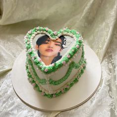 a heart shaped cake with an image of a woman's face on it