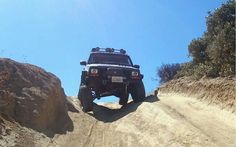 a jeep driving down a dirt road in the desert