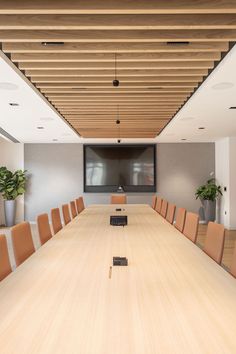 an empty conference room with wooden tables and chairs