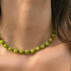 Features Lime Jade and brass beads. This funky necklace in a beautiful bright green shade adds a fun pop of color to any outfit. Jade is considered a protective stone and represents purity, serenity, and nurturing. It is also said to promote the health and wellness of the wearer. Carefully strung along 16" of beading wire and finished off with a gold-tone lobster closure. To maintain the quality of your jewelry and eliminate the risk of tarnishing and other wear, jewelry should be removed prior to entering any type of water. Avoid the use of harsh chemicals, perfumes, or oils around jewelry as well, to reduce the risk of wear. Green Gemstone Beads Necklace, Trendy Green Jewelry With Faceted Beads, Trendy Green Beaded Chain Necklace, Trendy Green Beaded Necklace For Gift, Trendy Green Beaded Necklace, Adjustable Green Beaded Necklace, Green Jade Beaded Chain Necklace, Trendy Handmade Green Necklaces, Green Jade Beaded Necklace With Large Beads