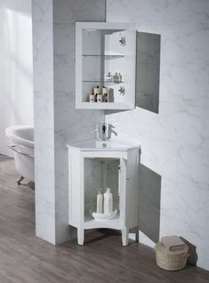 a white bathroom sink sitting next to a wall mounted cabinet with glass doors and shelves