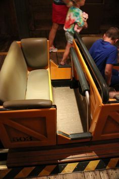 two children are riding on an escalator at the amusement park