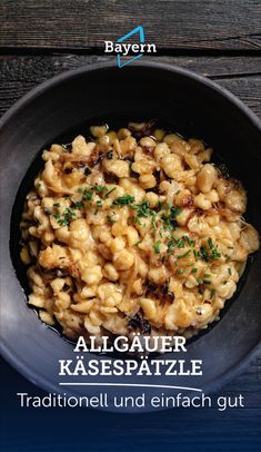 a bowl filled with macaroni and cheese on top of a wooden table