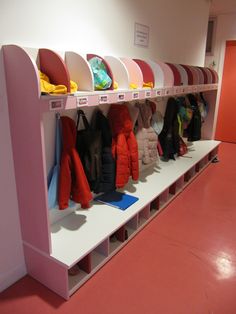 the coat rack is filled with coats and hats for children to wear on their own