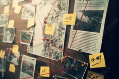 yellow post it notes attached to a bulletin board with red string and pins on it