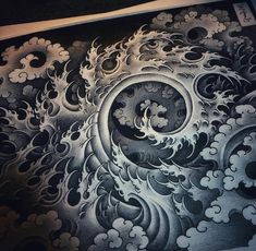 an intricately designed piece of art is shown in black and white, with waves coming out of it