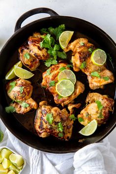 chicken with cilantro and limes in a cast iron skillet