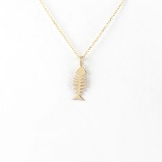 ✏About this necklace Our fishbone necklace is made of solid gold! The fishbone makes this beautiful and modern jewelry, which can become one of your favourite pieces. It's one of these times that a simple design- like a fishbone- can create an elegant jewelry, beautiful and easy to wear. For those who love the simplicity but they also want to get out of the box! Give it to you or your loved ones! ✏Details The pendant's dimensions are 14,5mm x 5,5mm/approx. 0.57'' x 0022'' and its thickness is 0, Fishbone Necklace, Gold Fish Necklace, Fish Bone Necklace, Symbol Of Strength, Skeleton Design, Fish Necklace, Nautical Jewelry, Jewelry Beautiful, Solid Gold Chains