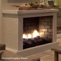 a fire place that is in the middle of a living room with furniture around it