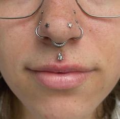 a woman with glasses and nose piercings on her nose