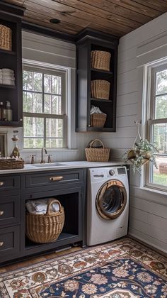 a washer and dryer in a room with wooden floors, windows, and rug