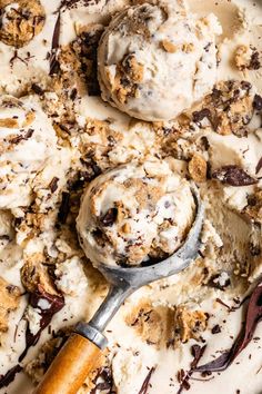 an ice cream dish with chocolate chips and cookies on top, ready to be eaten