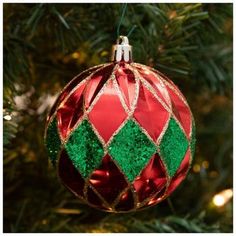 a red and green christmas ornament hanging from a tree