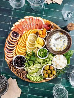 a platter filled with different types of food on top of a green tile floor