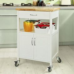 a white kitchen cart with wooden top on wheels