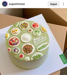 there is a green cake with many different toppings on the top and bottom layer