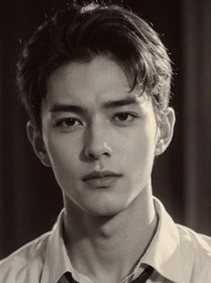 black and white photo of a young man with short hair wearing a shirt and tie