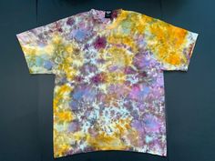 A custom designed and handmade tie-dyed t-shirt. The shirt is a high quality Hanes 6.1 oz Large made from soft, 100% ring-spun cotton.  The dyes we use are professional quality fiber reactive Procion dyes that resist fading after repeated washing. Multicolor Bohemian Relaxed Fit T-shirt, Relaxed Fit Tie-dye T-shirt With Natural Dye, Bohemian Multicolor Relaxed Fit T-shirt, Bohemian Style Multicolor Relaxed Fit T-shirt, Summer Tie-dye T-shirt With Natural Dye, Tie Dye T-shirt With Natural Dye And Short Sleeves, Summer Tie Dye T-shirt With Natural Dye, Tie Dye Short Sleeve T-shirt With Natural Dye, Summer Tie Dye Natural Dye T-shirt