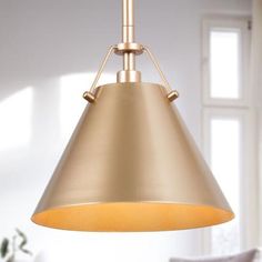 a light that is hanging from a ceiling in a room with white walls and windows