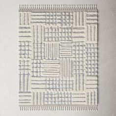 a white and grey rug with some lines on it