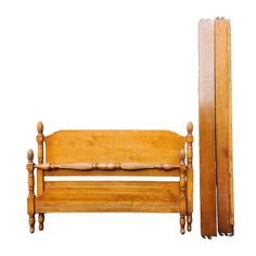 an old wooden bed with two skis next to it on a white background,