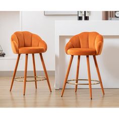 two orange bar stools sitting next to each other