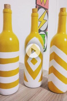 three yellow and white bottles sitting on top of a wooden table