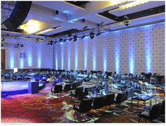 an empty conference room is lit up with blue and red lights for a special event