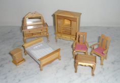 a doll house bedroom with furniture and accessories