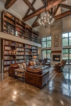 a living room filled with lots of furniture and bookshelves next to a fire place